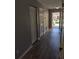 Hallway with tile and laminate flooring, offering seamless transitions between rooms at 4321 Winding River Way, Land O Lakes, FL 34639