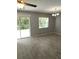 Living room with updated flooring, modern ceiling fan, and backyard views at 4321 Winding River Way, Land O Lakes, FL 34639