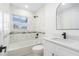 Modern bathroom features a white vanity, stylish tiling in the shower and tub with black fixtures at 4709 Eldorado Dr, Tampa, FL 33615