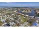 A high angle view of a canal neighborhood with mature trees and blue skies at 4901 Lansing St Ne, St Petersburg, FL 33703