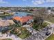 Well-manicured waterfront property with inviting front yard, arched entryway, red tile roof, and access to the Gulf at 4901 Lansing St Ne, St Petersburg, FL 33703