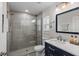 Modern bathroom featuring a tiled walk-in shower, blue vanity, and stylish fixtures at 4901 Lansing St Ne, St Petersburg, FL 33703