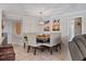 An open dining room features a wood table with upholstered chairs under a modern light fixture at 4901 Lansing St Ne, St Petersburg, FL 33703