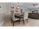 A quaint dining room is featured, boasting a wooden table, upholstered chairs, and an elegant modern light fixture at 4901 Lansing St Ne, St Petersburg, FL 33703