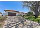 Charming home featuring lush landscaping, a spacious driveway, and a well-manicured lawn, perfect for curb appeal at 4901 Lansing St Ne, St Petersburg, FL 33703