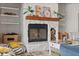 Close up of a cozy stone fireplace with a wood mantel and built-in shelving at 4901 Lansing St Ne, St Petersburg, FL 33703