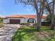 Inviting single-story home featuring a terracotta roof, arched entry, and well-maintained landscaping at 4901 Lansing St Ne, St Petersburg, FL 33703