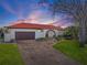 Charming home showcasing a well-manicured front yard, brick driveway, and inviting entrance at 4901 Lansing St Ne, St Petersburg, FL 33703