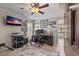 This home office is equipped with a ceiling fan, TV, and a window for natural light at 4901 Lansing St Ne, St Petersburg, FL 33703