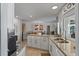 Well-appointed kitchen with white cabinets, granite countertops, and a kitchen island with a view at 4901 Lansing St Ne, St Petersburg, FL 33703