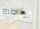 Bright kitchen with sleek white cabinetry, large island, and stainless steel sink at 4901 Lansing St Ne, St Petersburg, FL 33703