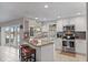 Open kitchen with granite countertops, white cabinetry, and a canal view from the sink at 4901 Lansing St Ne, St Petersburg, FL 33703