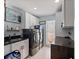 Well-equipped laundry room with sleek, dark appliances, modern countertops, and ample storage at 4901 Lansing St Ne, St Petersburg, FL 33703