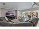 A cozy living room has a large sectional couch with sliding glass doors leading to a screened-in patio at 4901 Lansing St Ne, St Petersburg, FL 33703