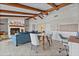 Bright living room with wood beamed ceilings, view to desk and dining areas, and stone fireplace at 4901 Lansing St Ne, St Petersburg, FL 33703