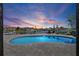 Beautiful, blue pool overlooking a serene canal at sunset at 4901 Lansing St Ne, St Petersburg, FL 33703