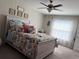 Cozy bedroom with a decorative bed, ceiling fan, and soft, neutral tones at 4908 Wild Senna Blvd, Tampa, FL 33619
