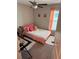 Cozy bedroom with a twin bed, ceiling fan, fluffy rug, and soft peach accents at 4908 Wild Senna Blvd, Tampa, FL 33619