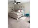 Cozy bedroom with a decorative bed, ceiling fan, and soft, neutral tones at 4908 Wild Senna Blvd, Tampa, FL 33619