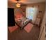 Warm bedroom with a full bed, ceiling fan, floral bedding, and pink rug and accents at 4908 Wild Senna Blvd, Tampa, FL 33619