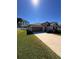 Charming single-story home with well-maintained lawn and a two-car garage at 4908 Wild Senna Blvd, Tampa, FL 33619