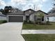 Charming single-story home with well-maintained lawn and a two-car garage at 4908 Wild Senna Blvd, Tampa, FL 33619