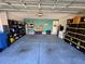 Spacious two car garage, with storage shelves and stacks of storage containers at 4908 Wild Senna Blvd, Tampa, FL 33619