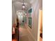 Inviting hallway featuring tile flooring, decorative wall art, and stylish furnishings at 4908 Wild Senna Blvd, Tampa, FL 33619