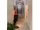 Inviting hallway featuring tile flooring, decorative wall art, and stylish furnishings at 4908 Wild Senna Blvd, Tampa, FL 33619
