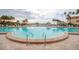 Large swimming pool with shallow end steps and clear, blue water at 5200 Brittany S Dr # 1710, St Petersburg, FL 33715