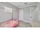 Bedroom with a pink metal canopy bed and neutral walls and flooring at 541 Ridgecrest Dr, Punta Gorda, FL 33982