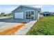 Home exterior highlighting an attached garage, sliding glass doors, and well-maintained landscaping at 541 Ridgecrest Dr, Punta Gorda, FL 33982