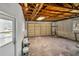 A utilitarian garage featuring a roll-up door, a large concrete floor, and exposed ceiling beams at 541 Ridgecrest Dr, Punta Gorda, FL 33982
