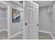 Hallway with gray tile floors, white trim, and an abstract painting on the gray walls at 541 Ridgecrest Dr, Punta Gorda, FL 33982