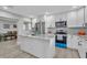 Bright kitchen boasts white cabinets, stainless appliances, and an island with marble countertop at 541 Ridgecrest Dr, Punta Gorda, FL 33982