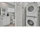 Laundry room has stacked washer/dryer with a door to the bathroom with toilet and sink at 541 Ridgecrest Dr, Punta Gorda, FL 33982