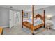 Main bedroom with an ornate wooden four-poster bed, side table and access to en-suite at 541 Ridgecrest Dr, Punta Gorda, FL 33982