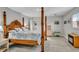 The primary bedroom features a four-poster bed, side table, decorative fireplace, and coastal artwork at 541 Ridgecrest Dr, Punta Gorda, FL 33982