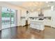 Modern kitchen with stainless steel appliances, white cabinetry, and barstool seating at 607 N Sterling Ave, Tampa, FL 33609