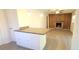 Open-concept kitchen island adjacent to the living room with wood-burning fireplace at 6205 Brandon Cir, Riverview, FL 33578