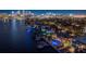 Aerial view of waterfront homes with pools, docks, and a beautiful cityscape skyline, showcasing luxury living at its finest at 72 Adalia Ave, Tampa, FL 33606