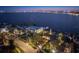 Stunning aerial view of waterfront homes with city skyline in the background, beautifully lit at twilight at 72 Adalia Ave, Tampa, FL 33606