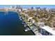 Stunning aerial view of waterfront property with private dock and city skyline in the background at 72 Adalia Ave, Tampa, FL 33606