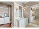 Bright bathroom with double vanities, marble countertops, and a view to another bathroom area at 72 Adalia Ave, Tampa, FL 33606