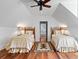 Charming bedroom features hardwood floors, twin beds, and ceiling design at 72 Adalia Ave, Tampa, FL 33606