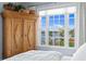Bright bedroom featuring a water view, wood floors, and large armoire cabinet at 72 Adalia Ave, Tampa, FL 33606