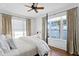 Cozy bedroom featuring a queen-sized bed, large windows with water views, and dark wood floors at 72 Adalia Ave, Tampa, FL 33606