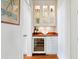 Charming butler's pantry with wine cooler, wooden countertop, and glass-front cabinets at 72 Adalia Ave, Tampa, FL 33606