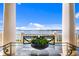 Covered patio, close up of a glass table with a lovely water view in the distance at 72 Adalia Ave, Tampa, FL 33606