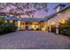 Elegant home featuring a paved driveway, lush landscaping, and a stately entrance, exuding curb appeal and sophistication at 72 Adalia Ave, Tampa, FL 33606
